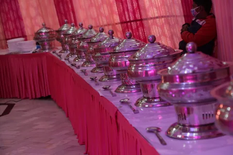 A buffet serving line with covered chafing dishes