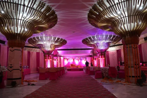 A decorated hall with sculpted columns and a central aisle